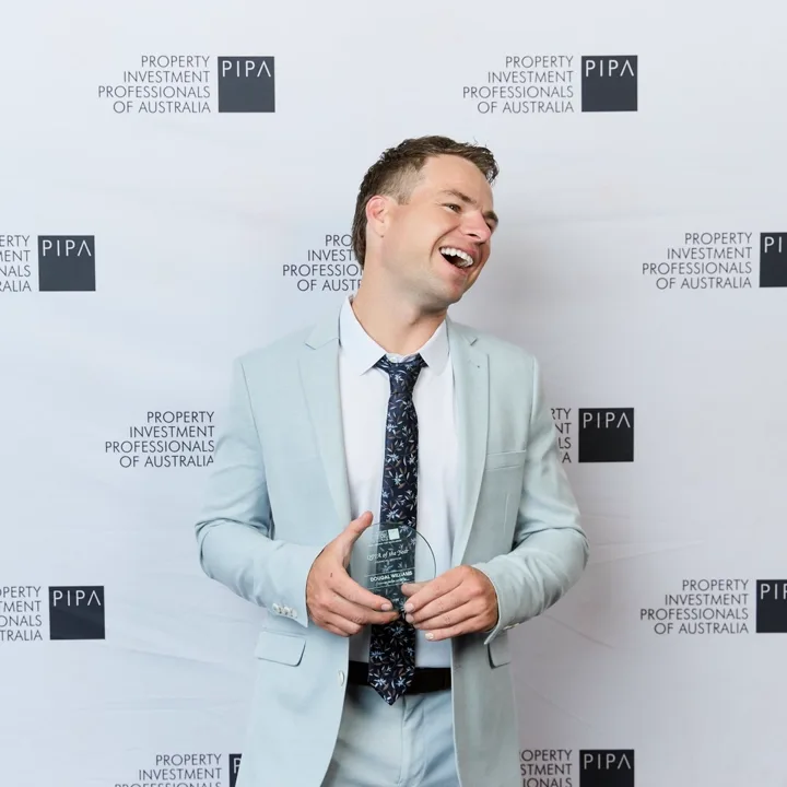 Dougal Williams holding the PIPA QPIA of the Year – Financial Services 2026 award